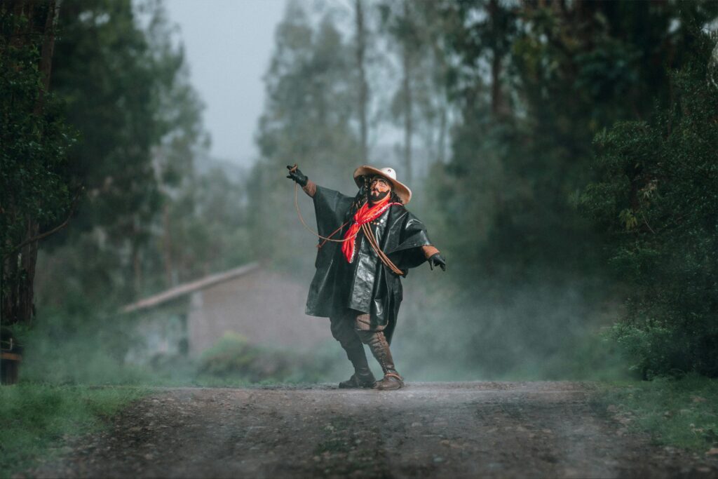 A traditional Peruvian dancer dressed in vibrant attire performing in a misty forest pathway.